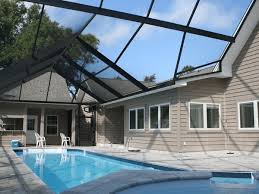 Out of view, there is a small dining table in an adjacent alcove. New Pool Enclosures Screenmobile
