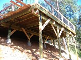 I would expect the design & construction of a deck on your roof would be more like $10,000 or more. F945npfhhs9a07r Medium Jpg 620 465 Building A Deck Sloped Backyard Deck Building Plans