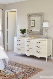 In her airy california cottage, the master bedroom is awash in a variety of white hues, from white painted planked walls to a white slipcovered chair to layers of soft and pretty white bedding. Bedroom Decor Dresser Smart Trik
