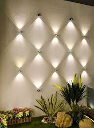 Light Wall Decor Multiple Lights Arranged On Wall Makes Decor Statement Modern Wall Decor Modern House Exterior Backyard Lighting