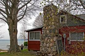 It features 4 bedrooms, 2 bedrooms, an outdoor shower, a deck, and a shaded backyard. Cottages Of Torch Lake Harris Beach Torch Lake Views