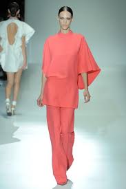 Image result for Images of the slim tunic worn with flared trousers on runway