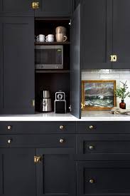 Brass Accents And Ebony Doors Make For A Darkly Dramatic Kitchen Victorian Kitchen Kitchen Design Kitchen Inspirations