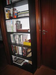 In large rooms, a simple shelf in the corner can tie together two wall bookcases, joining them seamlessly. Billy Bookcase Overhead Ikea Hackers