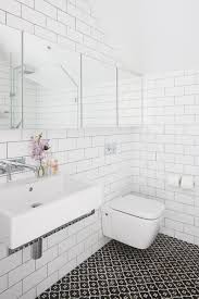 Light grey tiles with grey grout. White Tile Bathroom