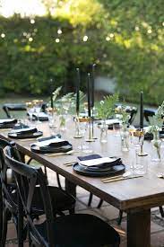 Set the table in autumn style with these stunning fall table decorating ideas. A Moody And Glamorous Fall Dinner Party Under The Stars Modern Dinner Party Dinner Party Table Dinner Party Table Settings