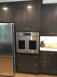 After sanding, apply a wood conditioner. Rich Dark Stain On Custom Maple Cabinets By Wood Mode Custom Tall Oven Cabinet Transitional Kitchen Houston By Bay Area Kitchens Houzz