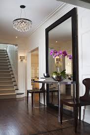 It will make your home look larger and spaces more your entry foyer is one of the best spots for a mirror. Large Full Length Mirror With Table And Chairs In Entryway Home Decor Home House Styles