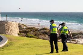 Police officers patrolling scarborough beach near perth, australia, on sunday after officials announced a lockdown for the region.credit. Australia Puts Perth In Lockdown Over One Covid Case The New York Times