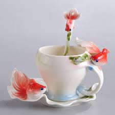 White ceramic mug with stainless steel spoon. China Franz Porcelain Goldfish Splendor Cup Saucer Spoon Set As 01306 China Tea Set And Cup Saucer Spoon Set Price