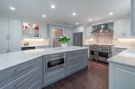 This transitional white and gray kitchen designed by normandy designer stephanie bryant has some of the clean lines of contemporary styles, and is blended with the chunky white granite countertop on the island offsets some of the finer details and helps land this kitchen in the transitional style. Contemporary White Gray Kitchen Cheryl Pett Design