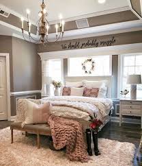 A contemporary farmhouse bedroom in neutrals, with a black metal bed, a metal sphere chandelier, a boho rug and a wreath. This Farmhouse Style Sign Cutout Measures 60 X 11 The Perfect Size To Fit Over A Queen Or King Farmhouse Master Bedroom Home Decor Bedroom Country House Decor