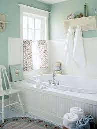 This tiny bathroom is made to feel much larger by the inclusion of mirror all around the room. Beach House Decorating Beach Cottage Interiors 6 Bath Design Ideas Http Nauticalcottagebl Country Bathroom Designs Cottage Bathroom Ideas Chic Bathrooms