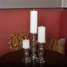 Glass lanterns filled with pillar candles are perfect accents for a mantel or porch, while dainty tea light candle holders can be placed on bookshelves or clustered on a coffee table to add a touch of shine to your space. Eastland Unique Mercury Glass Pillar Candle Holder 11 25 Save On Crafts