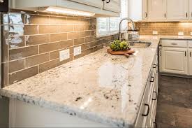 Learn about the most popular kitchen countertop materials. Colonial White Granite Kitchen Countertops With Light Brown Subway Backspla In 2020 White Granite Kitchen Granite Countertops Kitchen White Granite Countertops Kitchen