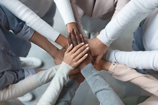 Team joining hands together