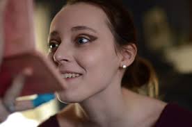 Sophomore Camille Vandergriff looks in the mirror at her new makeup. Photo  by Morgan Plunkett