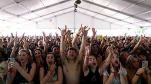 Aerial shot of people crowd excited with concert and dancing. Coronavirus When Will Concerts And Music Festivals Return