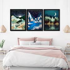 Comfortable big wooden framed bed with linen, pillows and blanket, nightstand beside and round mirror hanging on a white wall in a bright bedroom interior. Set Of 3 Frames With Abstract Landscape Girl Room Decor Wall Decor Ideas Modern Home Decor Abstract Wall Frames Digital Wall Decor Home Interior Ideas Best Wall Frames Buy Online At Best