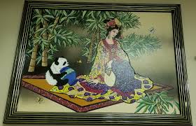 Asian watercolor painting. depicting a woman in traditional attire. Frame: It is encased in a gilded faux bamboo frame. Features;! a signature and a red stamp. Subject: Commonly titled "Oriental Princess" or "