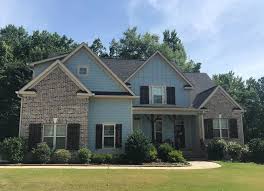 Red brick chimney, grey steel tile roof texture, gray tiled roofing, large detailed vertical closeup, modern residential house. Belfast Gray Classic Collection Georgia Cherokee Brick