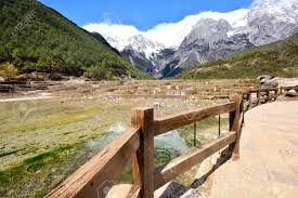 Jade dragon snow mountain is a mountain massif or small mountain range in yulong naxi autonomous county, lijiang, in yunnan province, china. Baishuihe Waterfall In Front Of Yulong Or Jade Dragon Snow Mountain In The Background Lijiang China Stock Photo Picture And Royalty Free Image Image 145225778