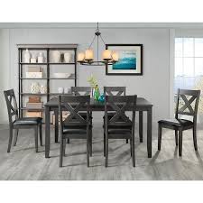 White dining table with silver legs, paired with blue upholstered chairs and set on a gray and white rug, in a room with dark blue curtains and decor. Gray Dining Room Sets At Lowes Com