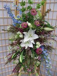 A Beautiful Funeral Spray Including White Lilies Bells Of Ireland Mums Delphinium Memorial Flowers Christmas Floral Arrangements Large Floral Arrangements