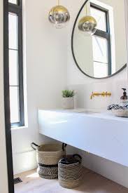 A floating vanity in a beautiful bathroom gives the illusion of added space, and floating vanities create a chic style that's distinctly contemporary. The Forest Modern Posh Steel Powder Bathroom The House Of Silver Lining