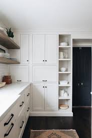 White shaker cabinetry with black countertops and glass by south shore decorating. Vertical Kitchen Display Shelves Transitional Kitchen