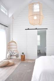 Under A Vaulted Ceiling A White Shiplap Wall Frames A Shiplap Bar Door Concealing An En Suite Bathroom W White Shiplap Wall Ship Lap Walls Plank Wall Bedroom