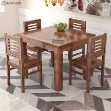 The kitchen table set includes a table and four chairs. Diest Wooden 4 Seater Dining Table Set Decornation