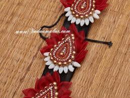 Flower power all the way with a simple bun covered with flowers. South Indian Bridal Hair Accessories Jada Billalu Green Artificial Jasmine Flowers