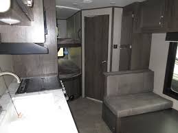 Charcoal interior, enclosed underbelly, morryde step above steps, bedspread, queen bed, wardrobes, dinette, pantry, microwave, cooktop, refrigerator, double bunk beds, shower, outside kitchen with refrigerator, sink, and grill, 13'. 2020 Jayco Jay Flight Slx 224bh