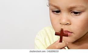 Little Boy Praying Holding Wooden Cross Stock Photo 1106058755