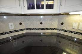 Cool White Diagonal Ceramic Wall Tile Combine With Black Striped Glass Backsplash And W Kitchen Backsplash Designs Backsplash Designs Marble Backsplash Kitchen