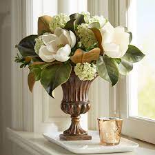 Magnolia is a genus of more than 200 species in the family of magnoliaceae. Magnolia Arrangement In Fluted Urn Church Flower Arrangements Flower Vase Arrangements Beautiful Flower Arrangements