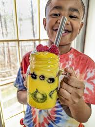 Raw vegan smoothie bowl with mango and blueberries