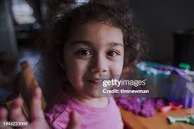Portrait Of An Autistic Girl Playing With Sensory Toy High-Res Stock Photo 