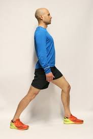 Standing hip flexor stretch with pelvic tilts. How To Stretch After A Run Nhs