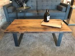 Coffee table with a modern translation of industrial design with a reclaimed wood look coupled with metal frame and exposed metal bolt heads that is a great look. Home Furnishings Grain Designs