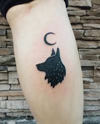 Angry wolf and moon tattoo. A Black Wolf And Crescent Moon Tattoo Inked On The Right Calf Wolf And Moon Tattoo Small Wolf Tattoo Moon Tattoo Designs