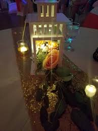 Ikea Lanterns Are Made Elegant With A Simple Fresh Rose Arrangement Fairy Lights Lantern Centerpiece Wedding Reception Table Centerpieces Greenery Centerpiece