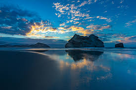 The following are your classic white sand / clear blue water type beaches. Wharariki Beach Sunset Takaka South Island New Zealand