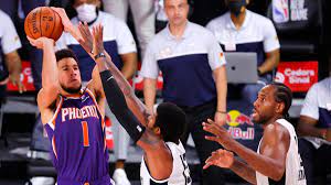 Phoenix suns guard devin booker, left, shoots over clippers forwards paul george, center, and kawhi leonard at the buzzer in the clippers. Devin Booker Drains Amazing Buzzer Beater Against Clippers As Suns Remain Unbeaten In Bubble Cbssports Com