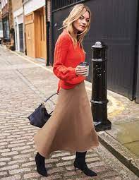 Compose A Bright Winter Outfit Of A Beige Midi Skirt A Coral Sweater Black Boots And A Black Bag Midi Skirt Winter Coral Sweater Outfit Tweed Midi Skirt