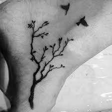 Meaningful Simple Birds On A Branch Tattoo Two Birds Flying Above A Tree With Several Branches Small Meaningful Tattoos Done In Black Ink And Sym In 2020 Ankle Tattoo Men Tattoos For Guys Small Tattoos For Guys