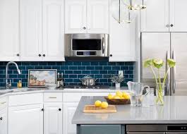 Blue And White Kitchen With A Corner Sink Featuring Dark Blue Subway Tiles W Blue Kitchen Tiles Blue Tile Backsplash Kitchen Backsplash Kitchen White Cabinets