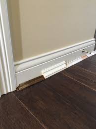 Transitions between a wood floor and a vertical surface under cabinetry. Shoe Moulding