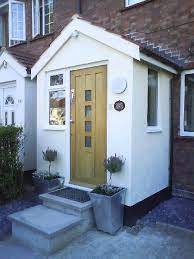 The front entrance is through paired front doors with a colored glass transom above. 11 Extentions Ideas In 2021 House Extensions House Extension Design House Exterior